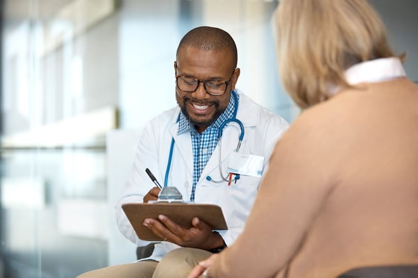 Doctor discussing medical record with female patient