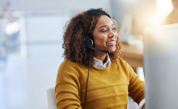 Customer service adviser helping a customer over the phone.