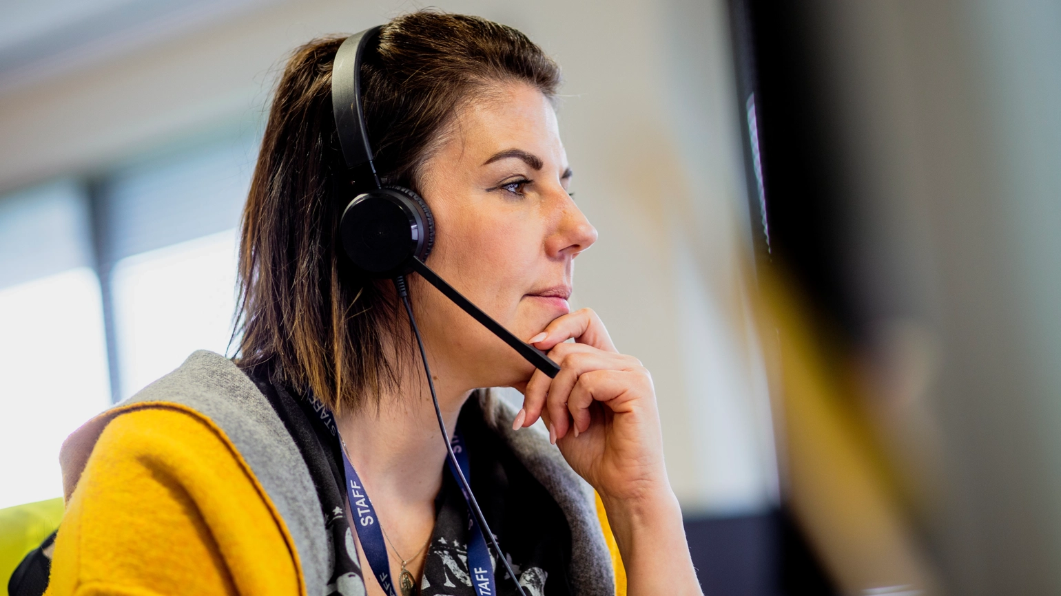 Female with a headset working in office Female with a headset working in office