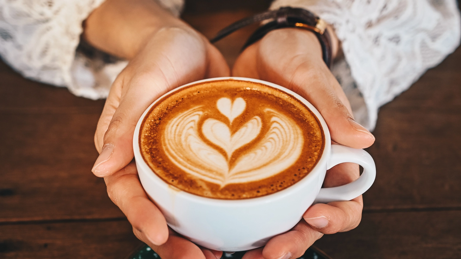 Coffee mug in female hand Coffee mug in female hand