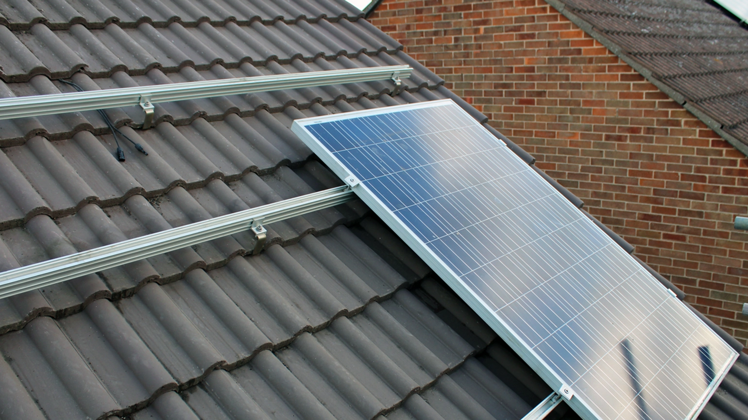 Photo of solar panel attached in house roof Photo of solar panel attached in house roof