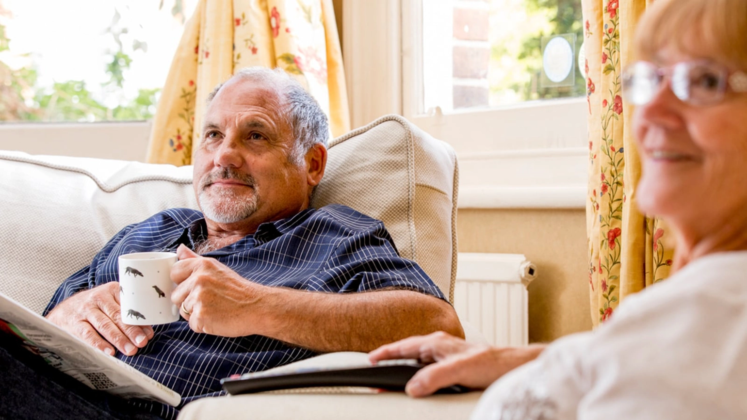 Elderly couple in their living room Elderly couple in their living room