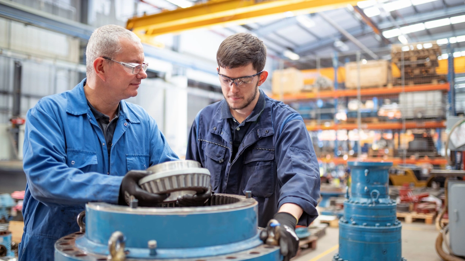 Two engineers working together checking machine Two engineers working together checking machine