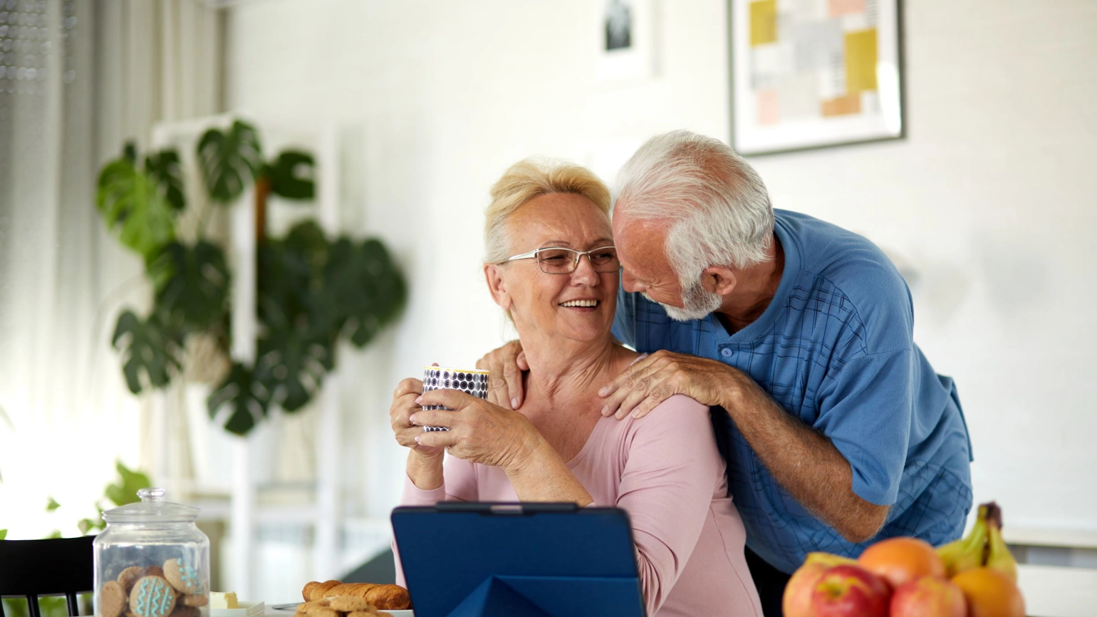 Elderly couple in their dining table looking each other Elderly couple in their dining table looking each other