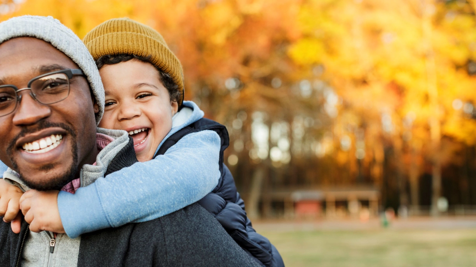 Man giving boy a piggy back Man giving boy a piggy back