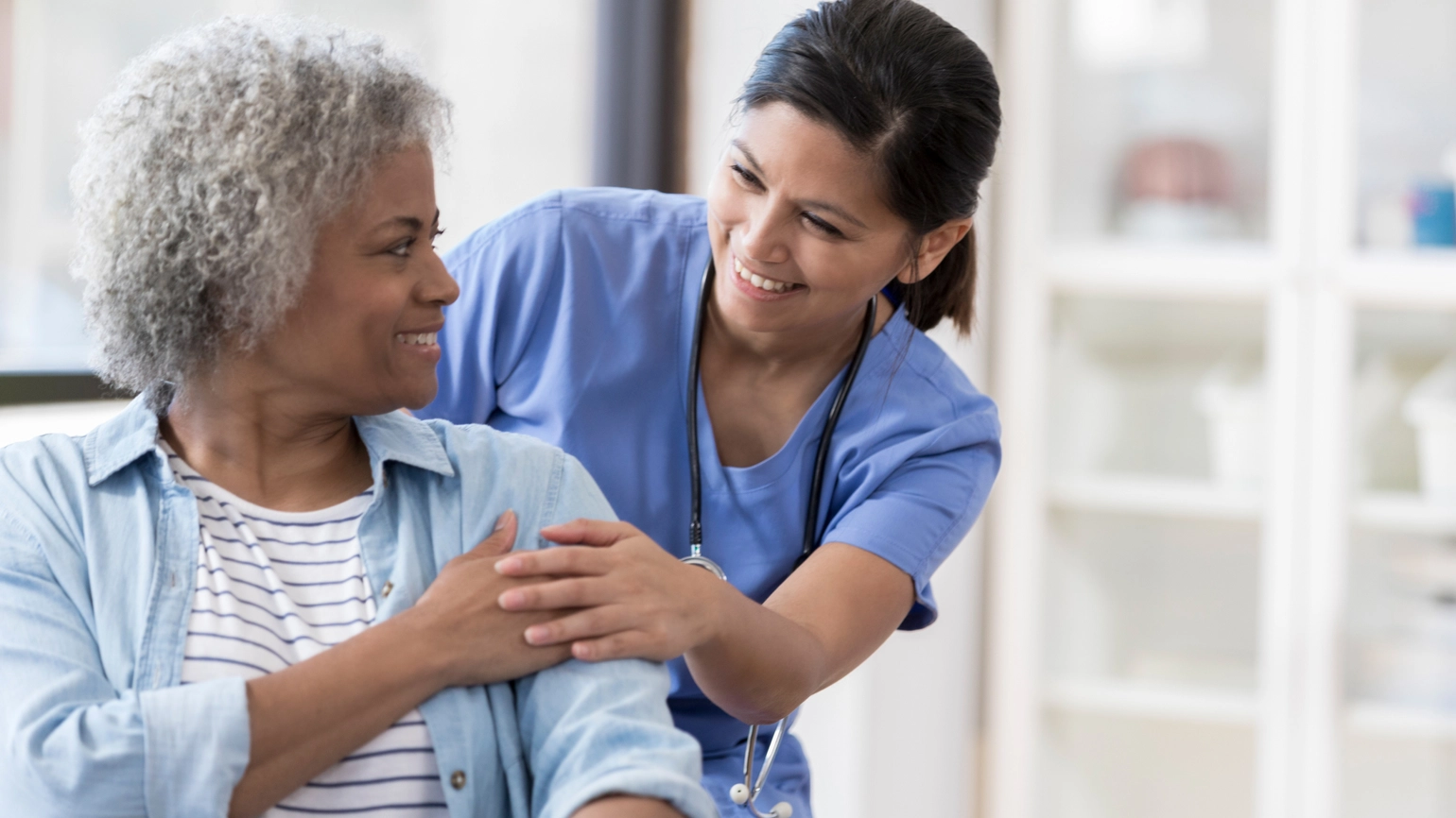 Female doctor checking her elderly female patient Female doctor checking her elderly female patient