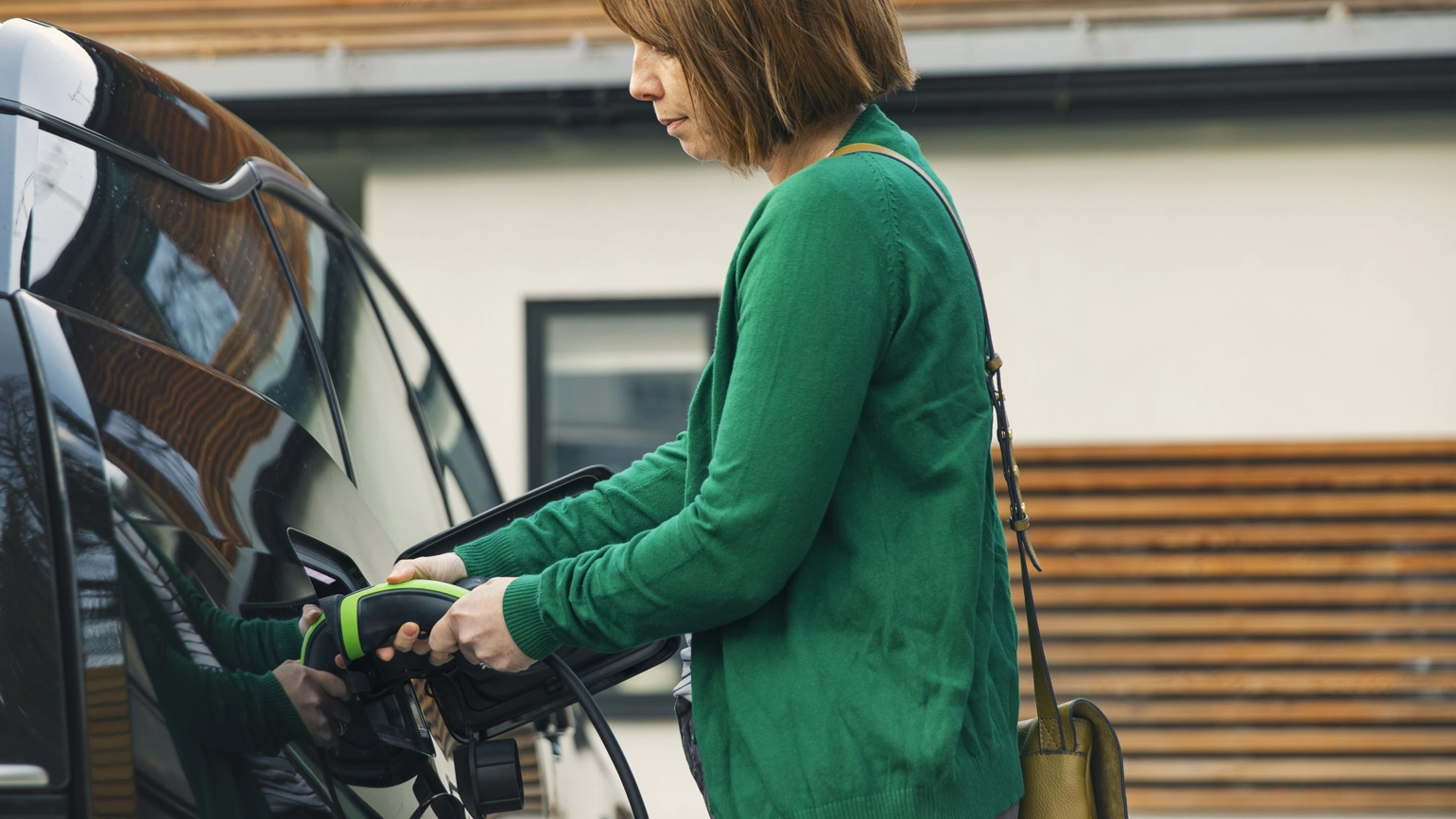 Female driver charging electric car Female driver charging electric car