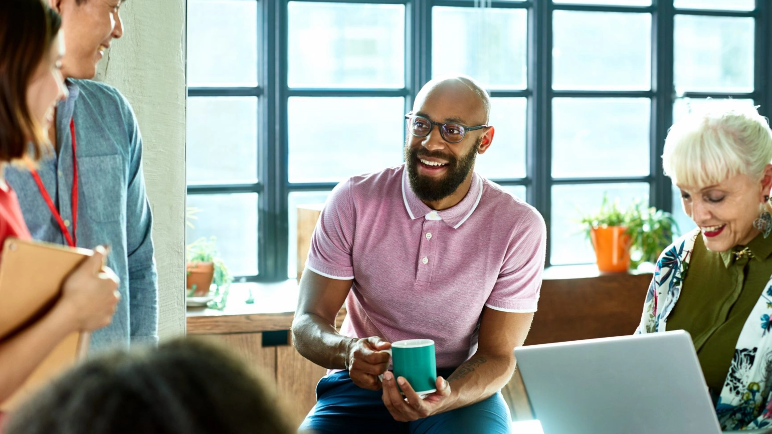 Five colleagues in a meeting chatting in the office Five colleagues in a meeting chatting in the office
