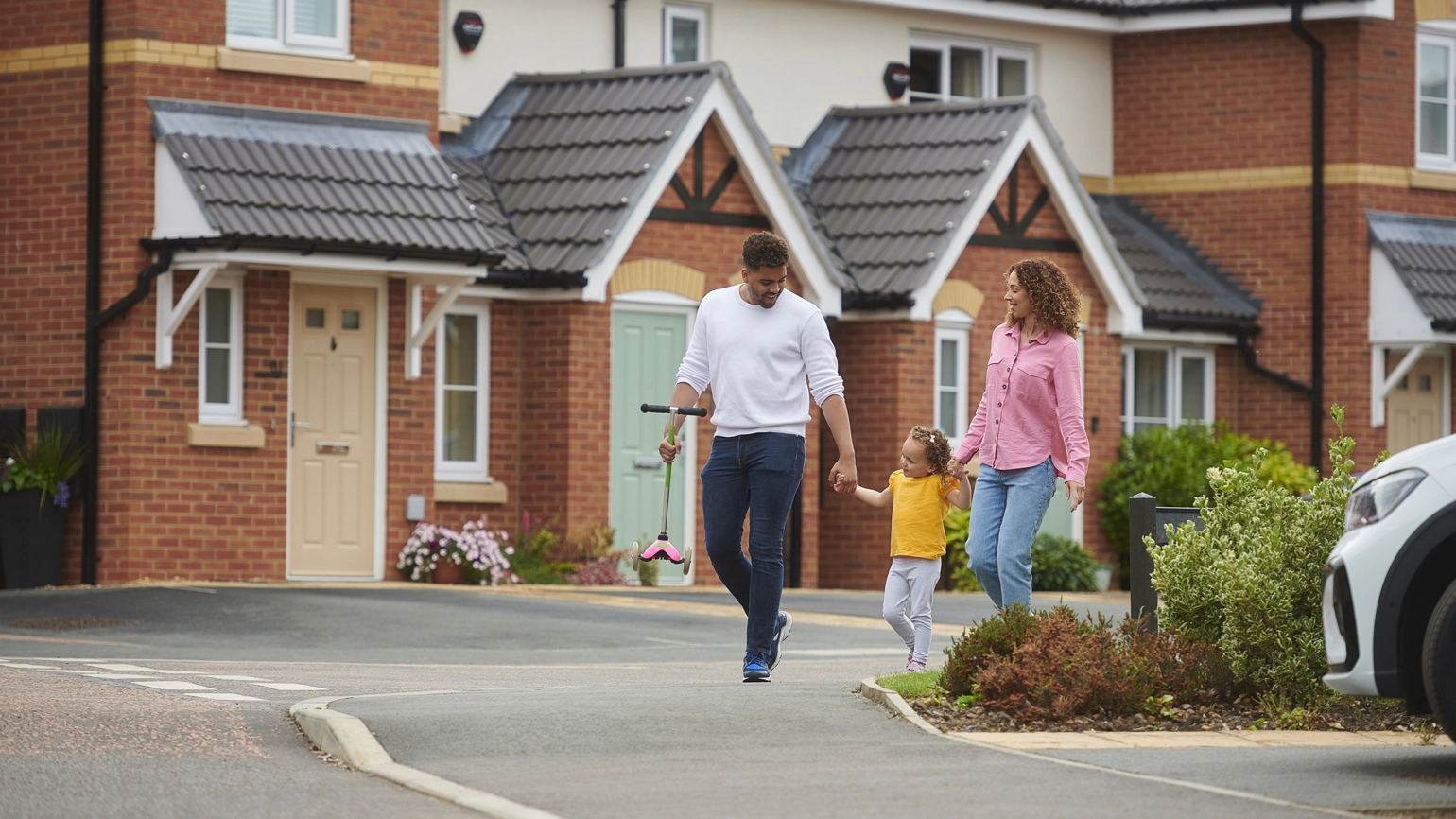Mother, father and a daughter walking all together holding hands Mother, father and a daughter walking all together holding hands
