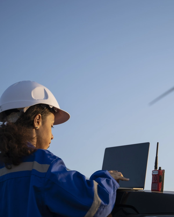 A female engineer working on wind farm, using laptop. A female engineer working on wind farm, using laptop.