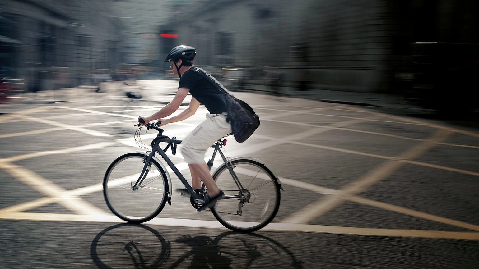 Male biker riding a bike in the street  Male biker riding a bike in the street