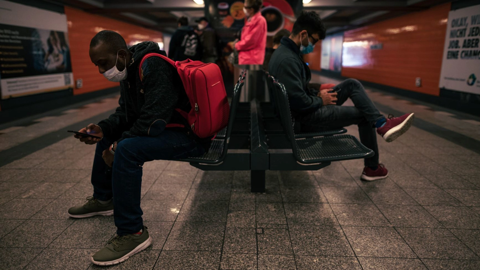 Tube passengers waiting for the tube in the station during covid wearing face masks Tube passengers waiting for the tube in the station during covid wearing face masks