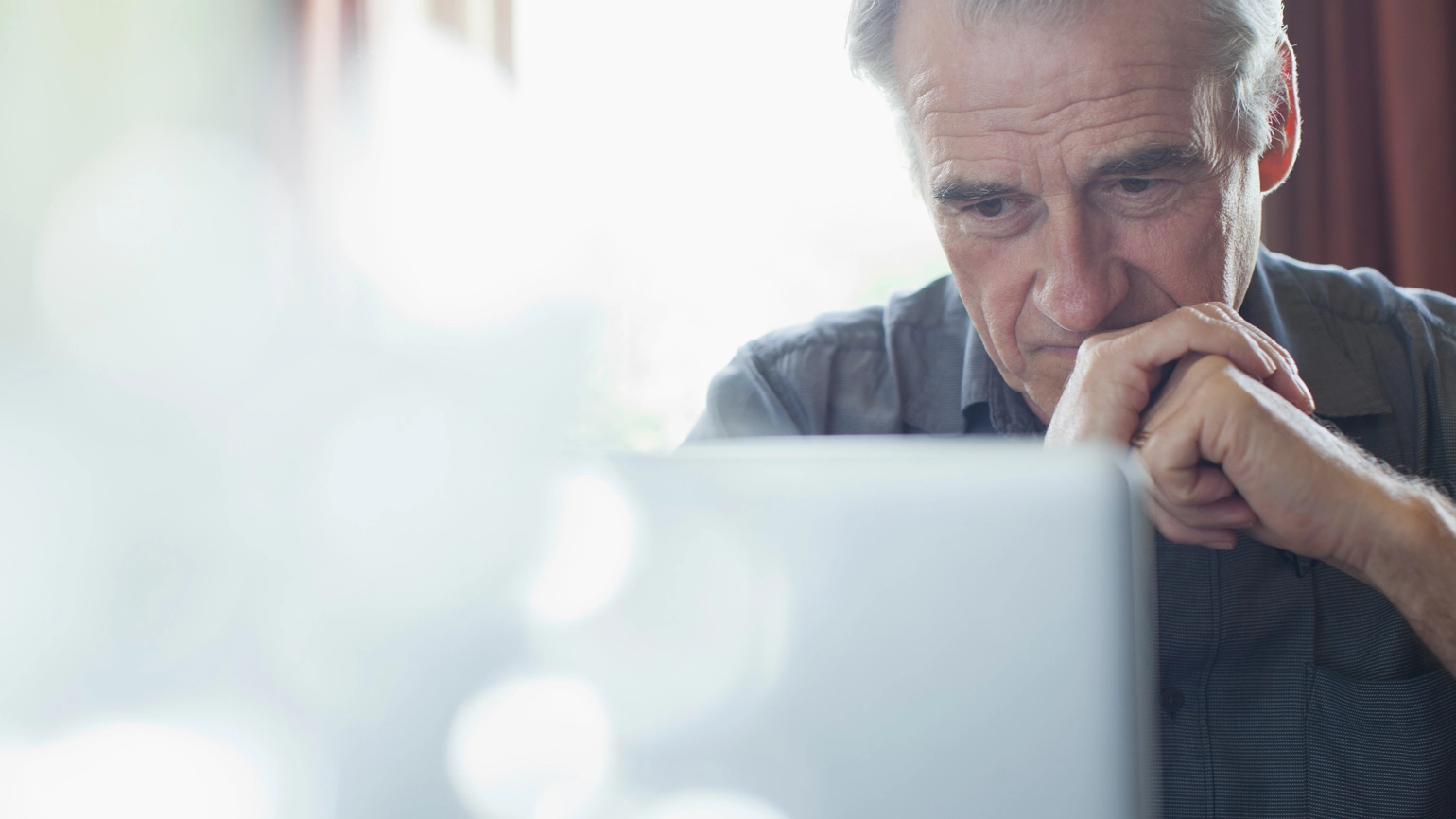 Elderly man looking his laptop Elderly man looking his laptop