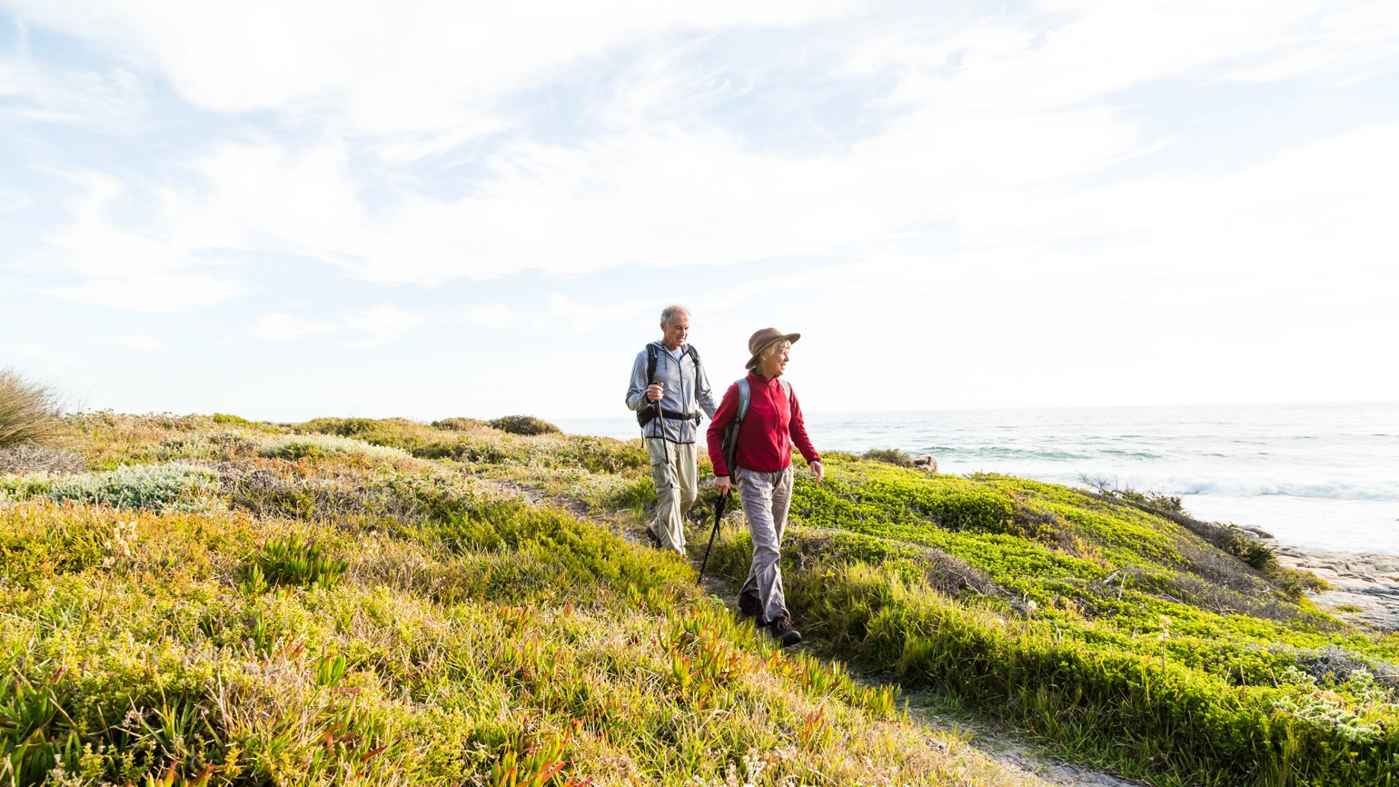 elderly couple hiking cliff near the beach elderly couple hiking cliff near the beach