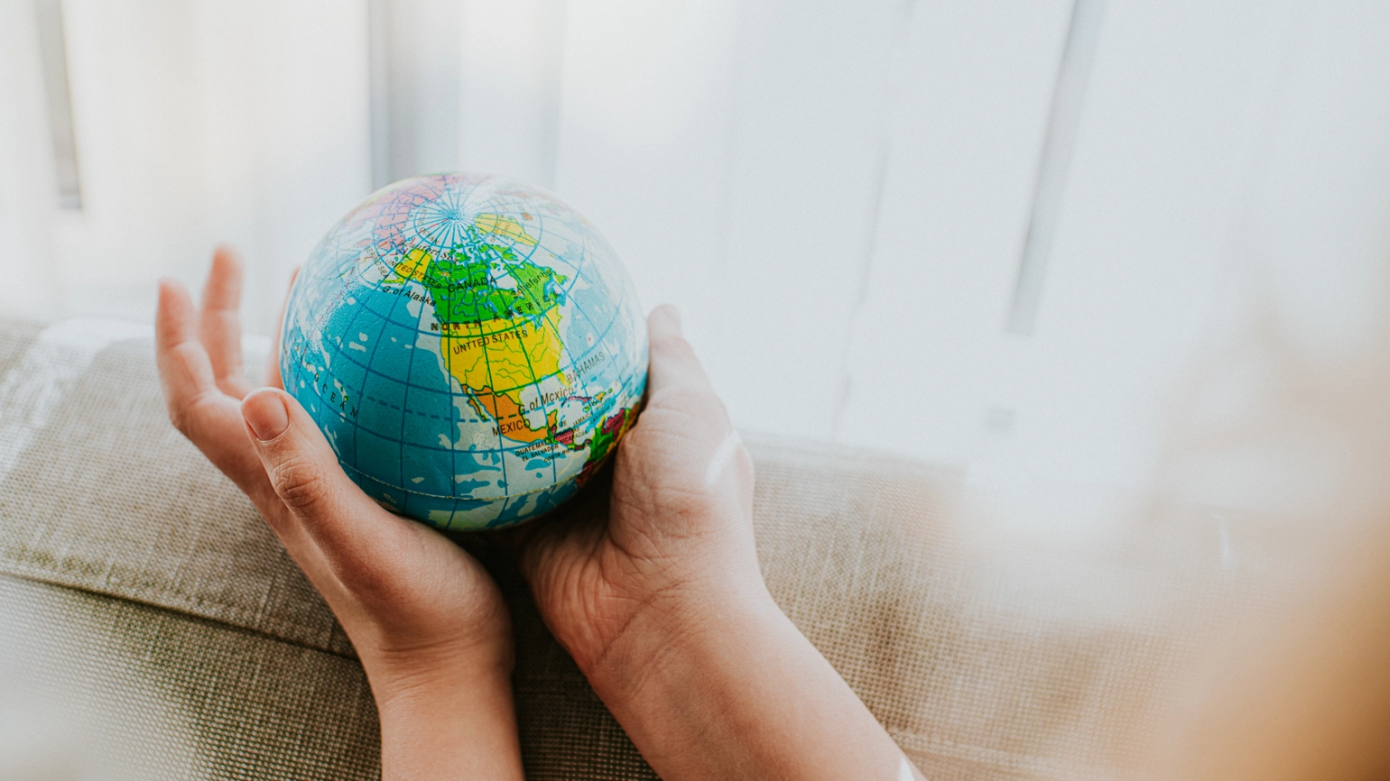 Image of hand holding a globe Image of hand holding a globe