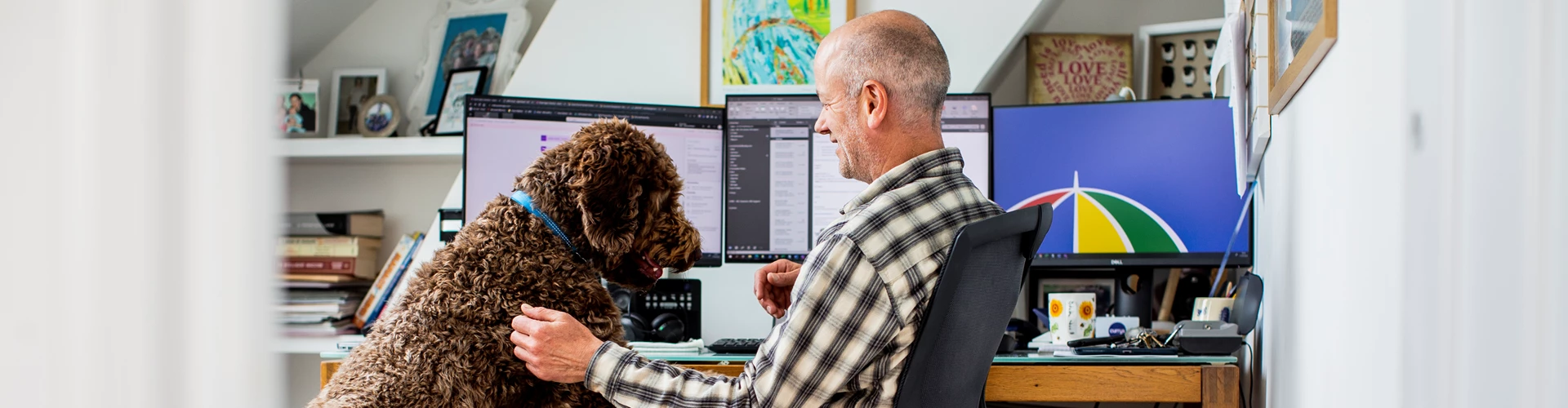 Man sitting at desk with computer screen showing L&G logo