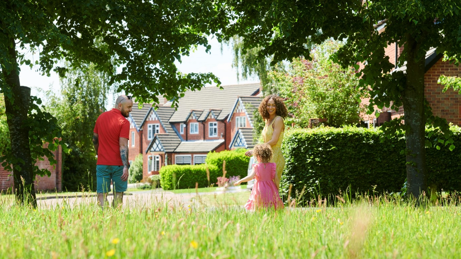 Male, female and their young daughter enjoying in the garden Male, female and their young daughter enjoying in the garden
