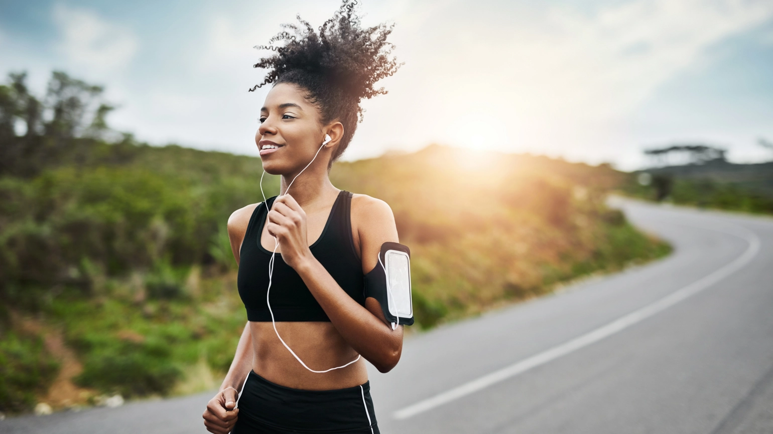 Female runner running with her headsets Female runner running with her headsets