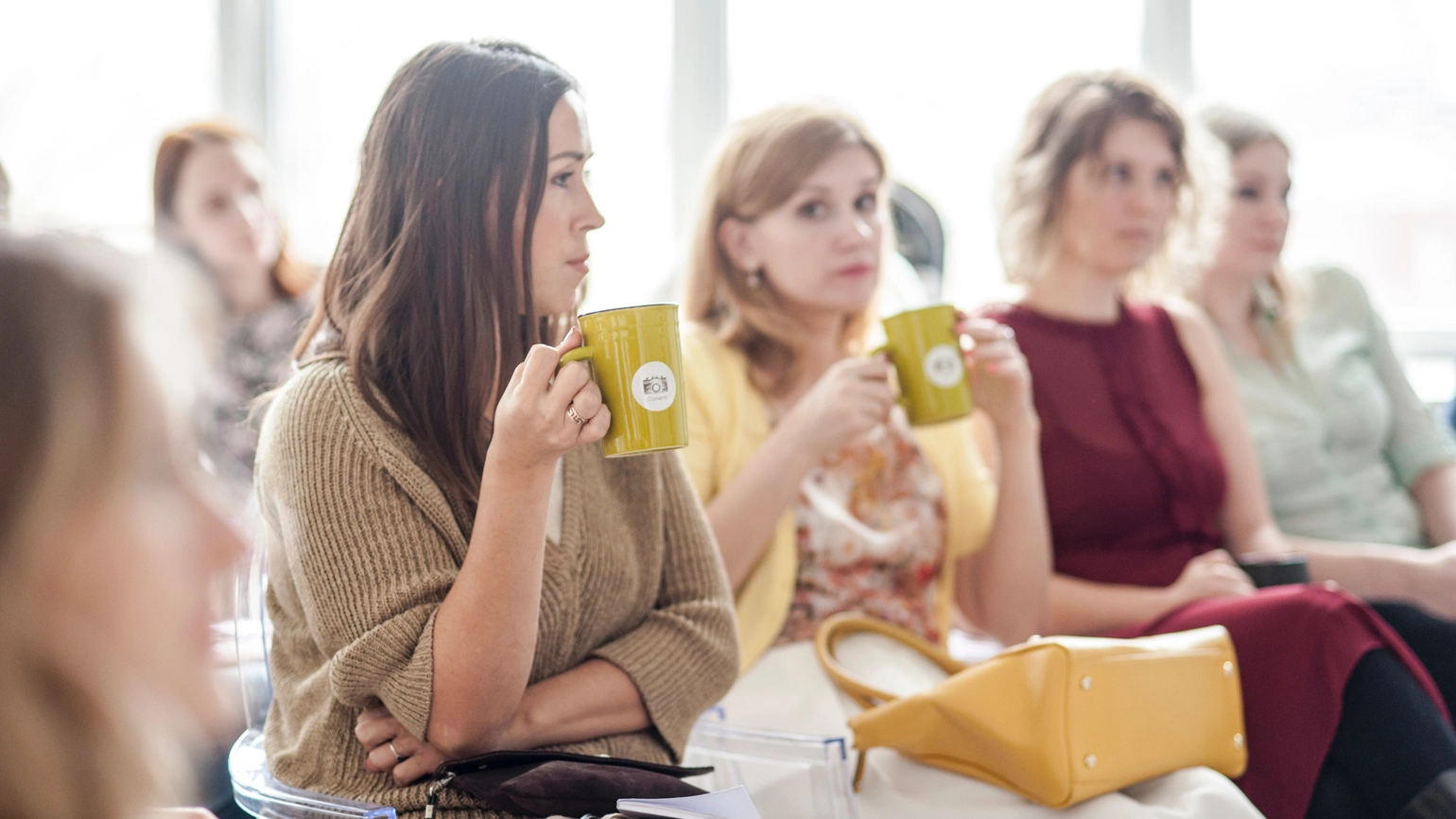 Female audiences in the meeting holding mug Female audiences in the meeting holding mug