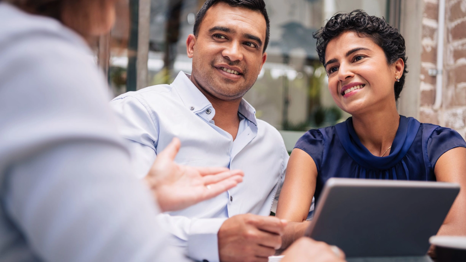 Three colleagues working and chatting with their Touch Pad Three colleagues working and chatting with their Touch Pad