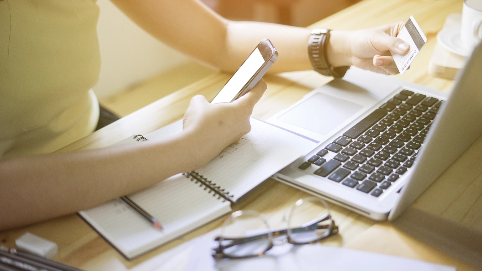 Female paying with her credit card at her desk Female paying with her credit card at her desk