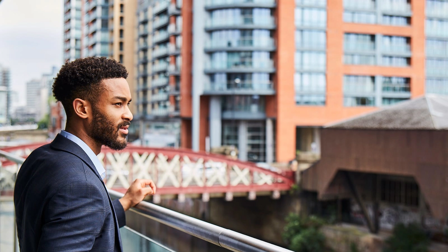 Male standing in the terrace looking outside Male standing in the terrace looking outside