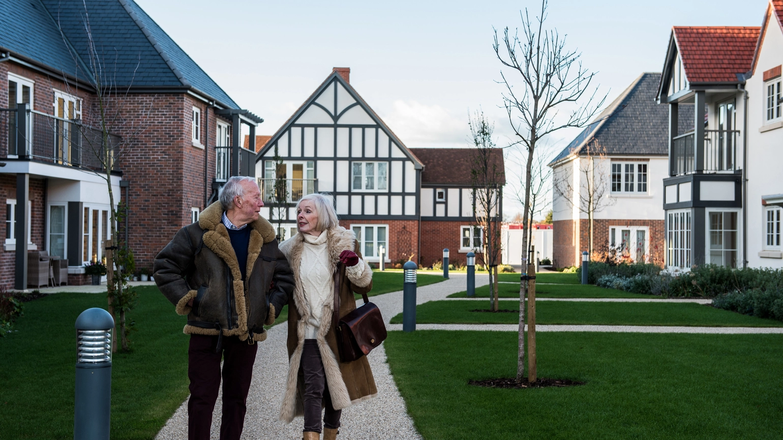 Elderly couple in their retirement home walking  Elderly couple in their retirement home walking
