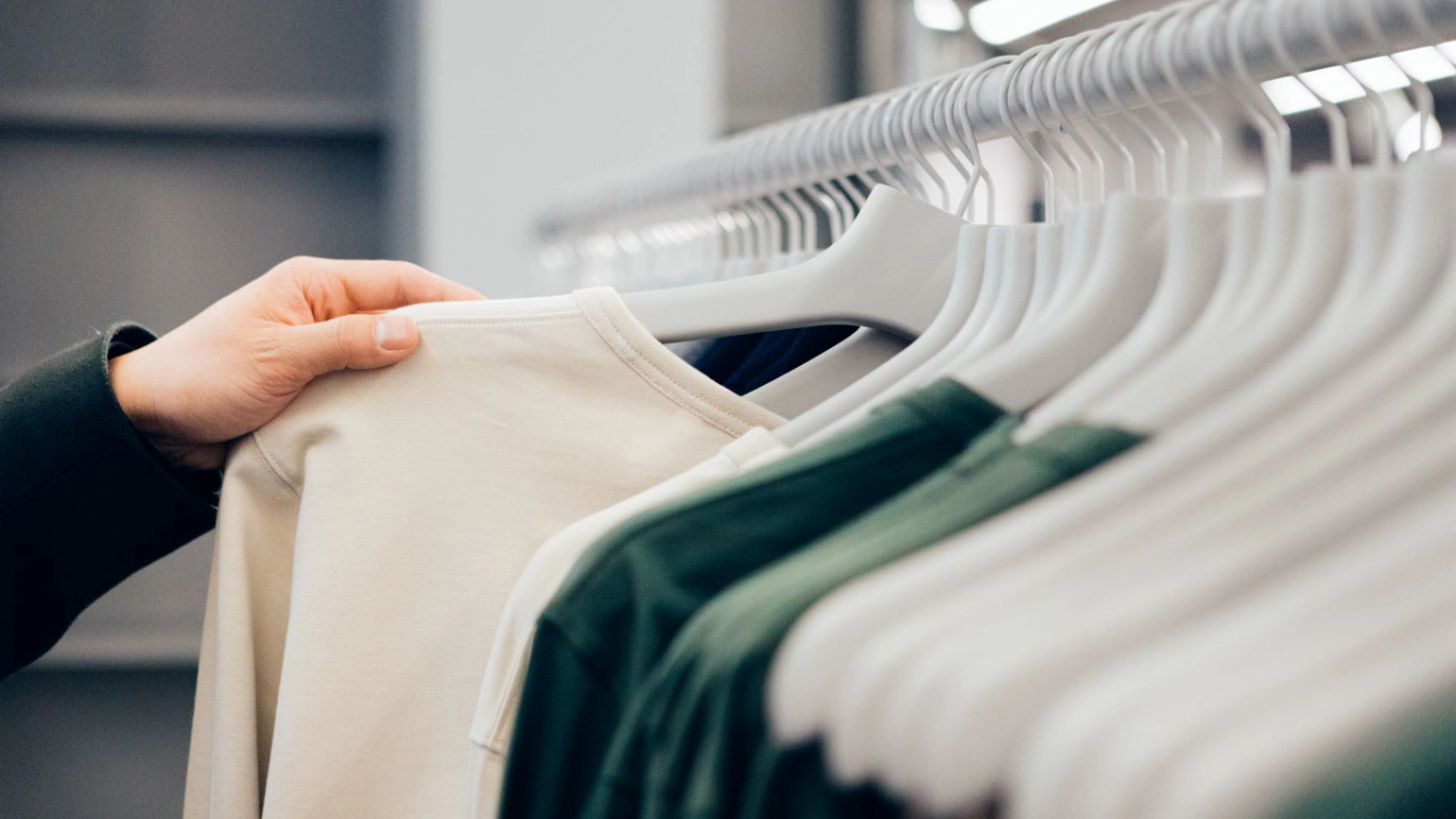 Hands choosing clothes on the rack Hands choosing clothes on the rack