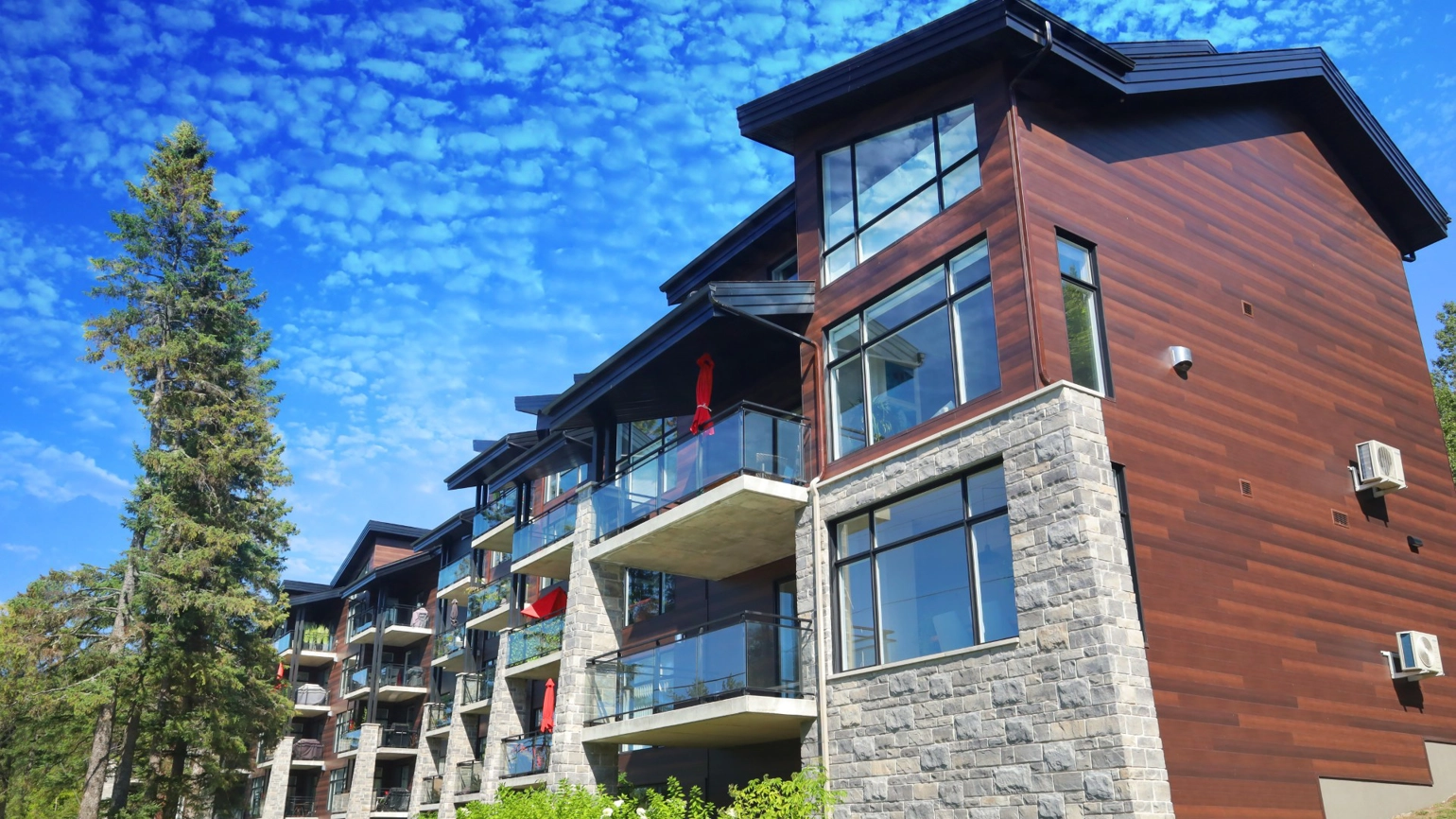 Photograph of exterior of residential home against a blue sky Photograph of exterior of residential home against a blue sky