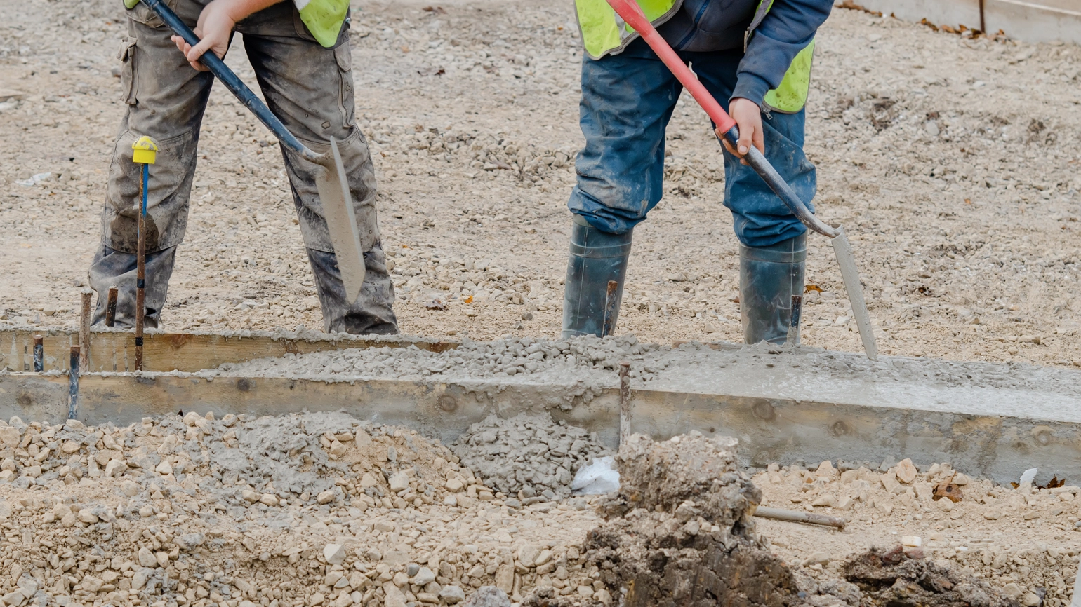 Two construction workers working in construction area Two construction workers working in construction area