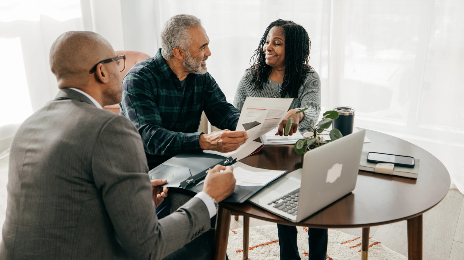 Middle aged couple talking with their business advisor in Dining room Middle aged couple talking with their business advisor in Dining room