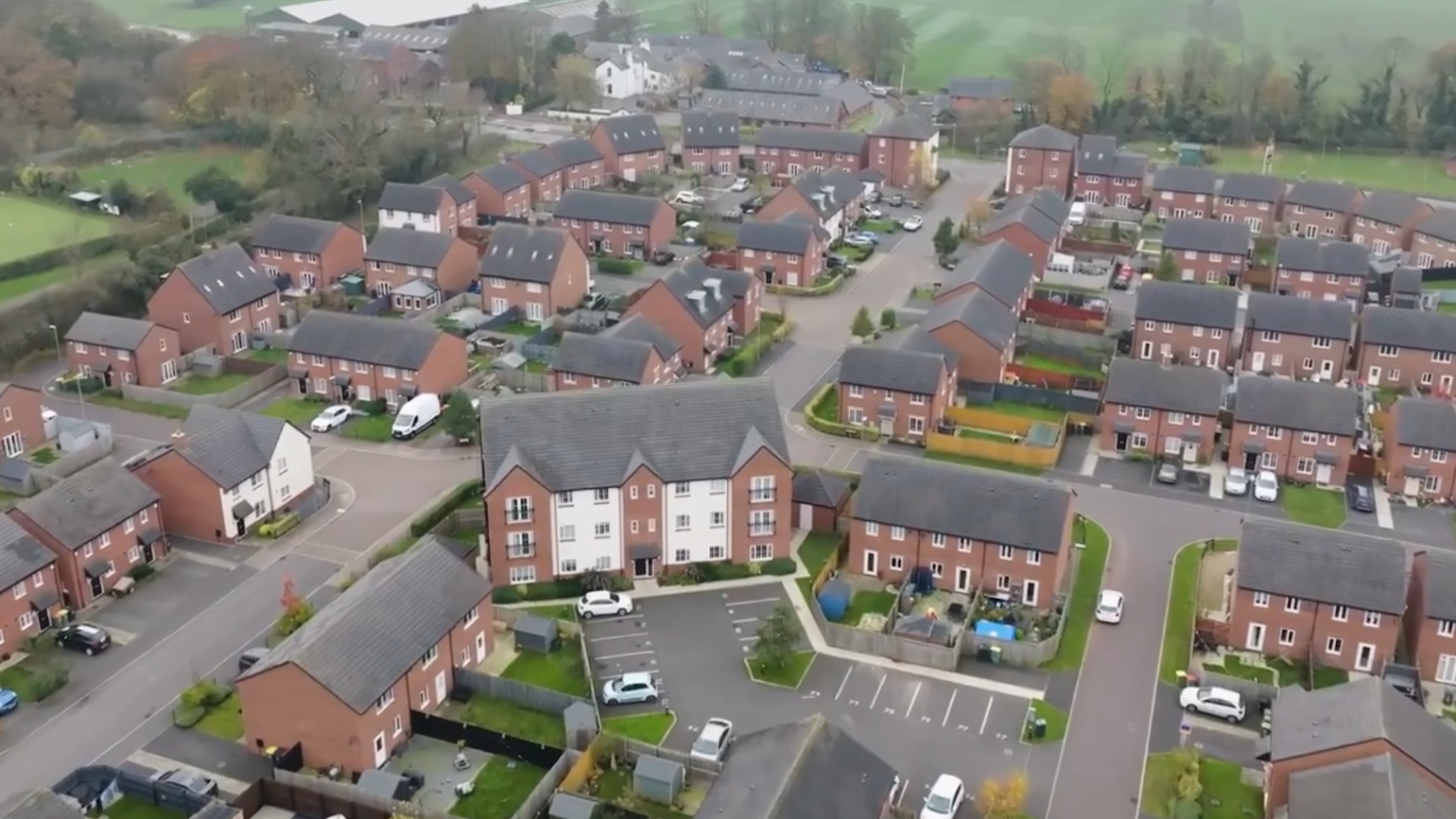 Aerial shot of a neighbourhood of red brick houses. Aerial shot of a neighbourhood of red brick houses.