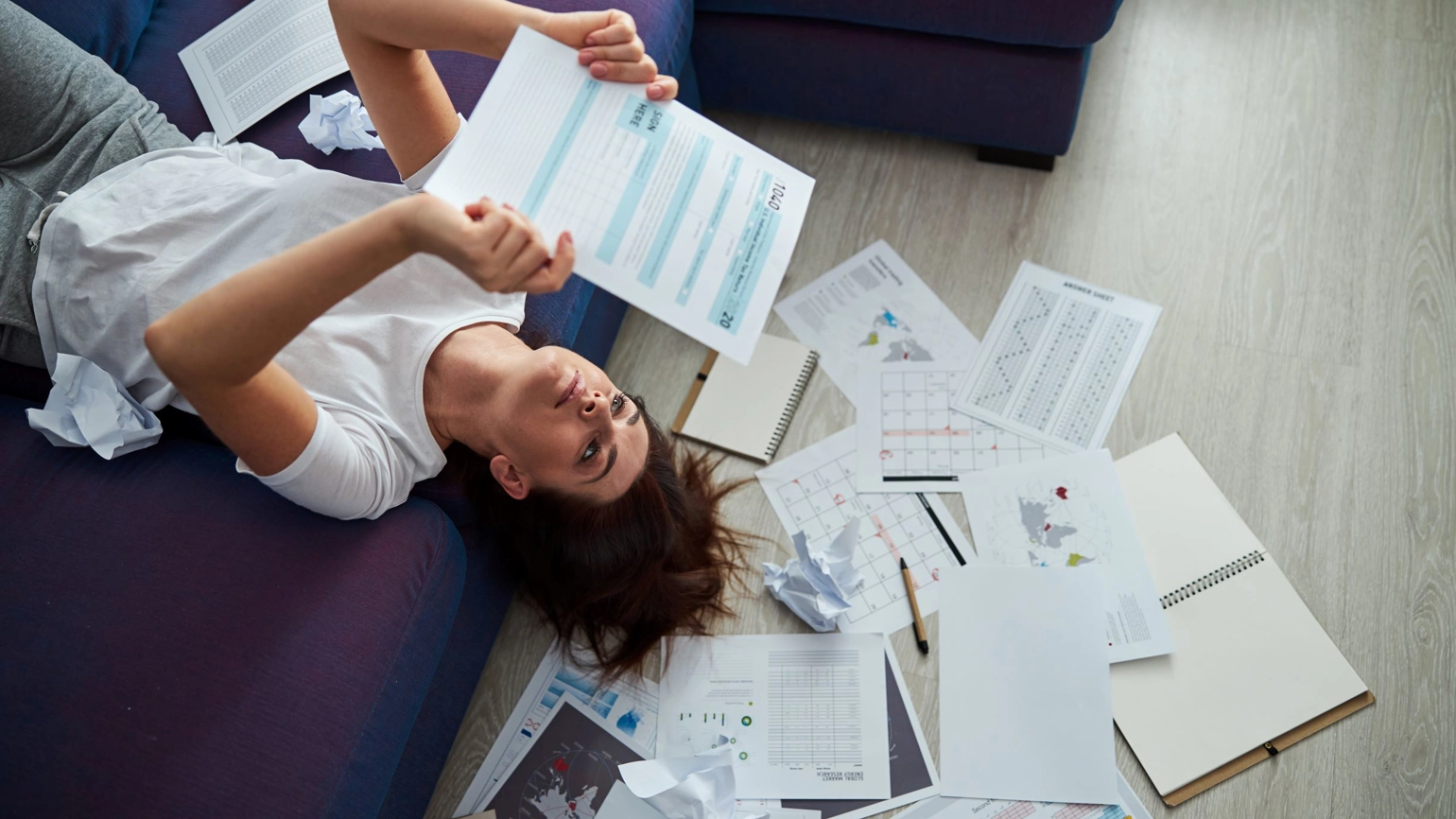 Female checking bills in the sofa Female checking bills in the sofa