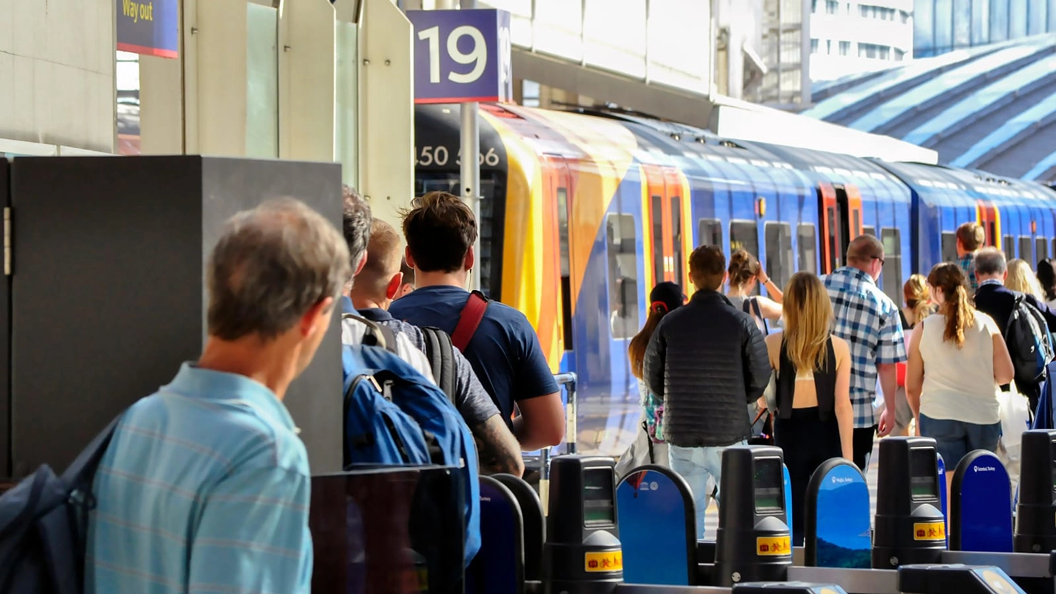 Passengers waiting for a train in the platform Passengers waiting for a train in the platform