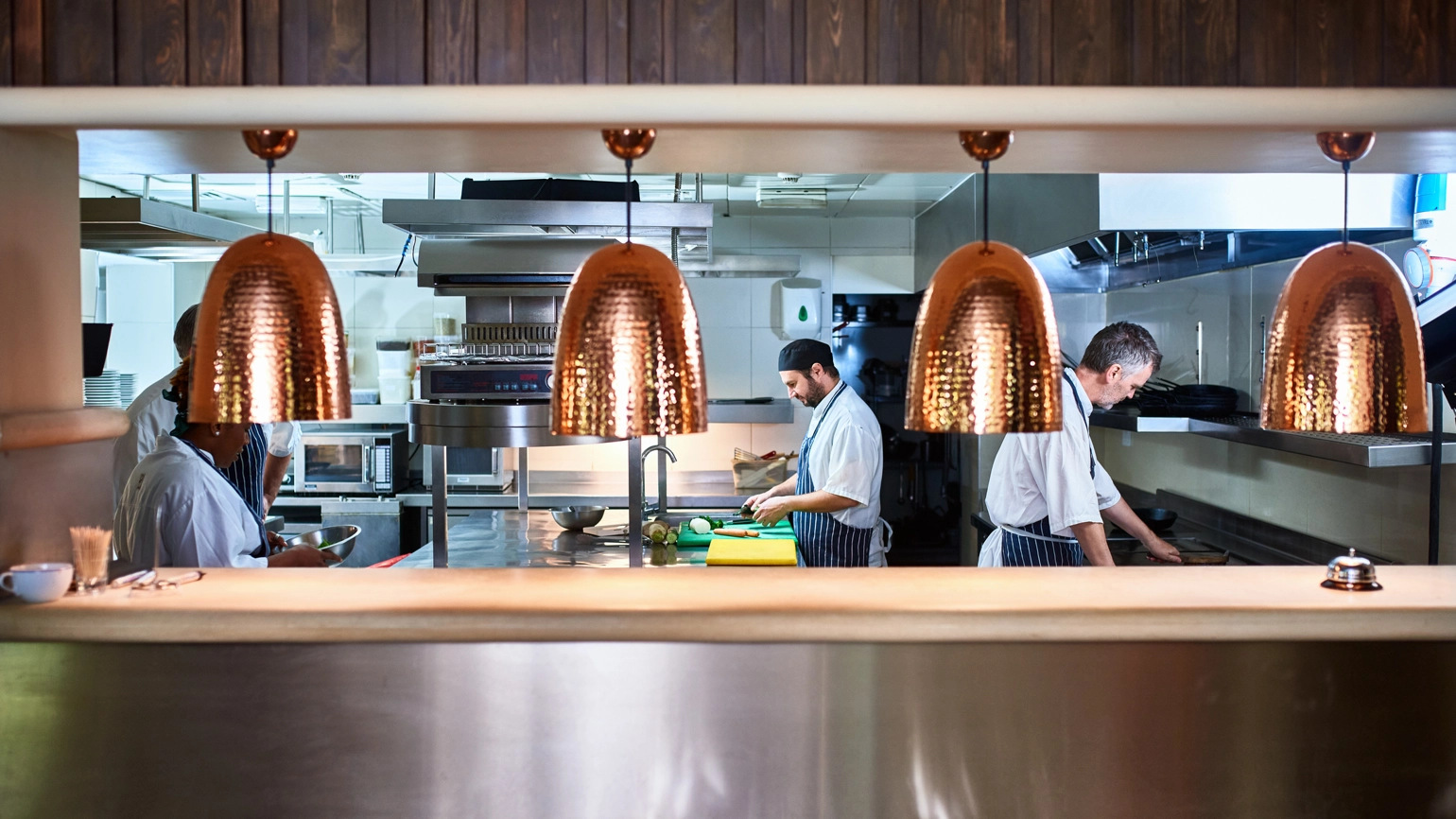 Busy restaurant chefs cooking in the kitchen Busy restaurant chefs cooking in the kitchen
