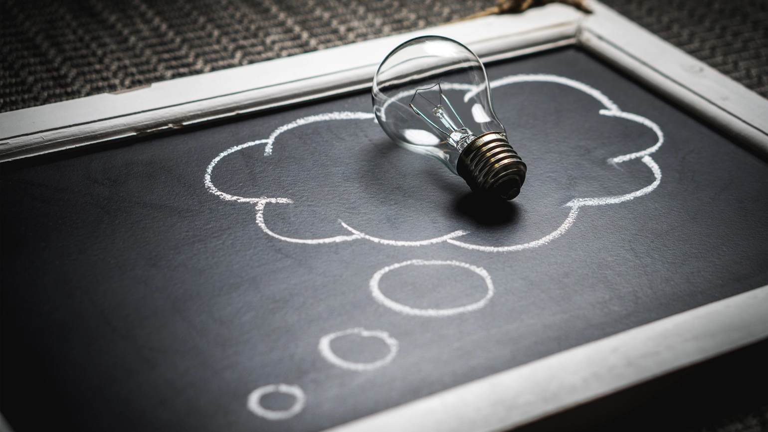 Illustration of lightbulb in thinking cloud Illustration of lightbulb in thinking cloud
