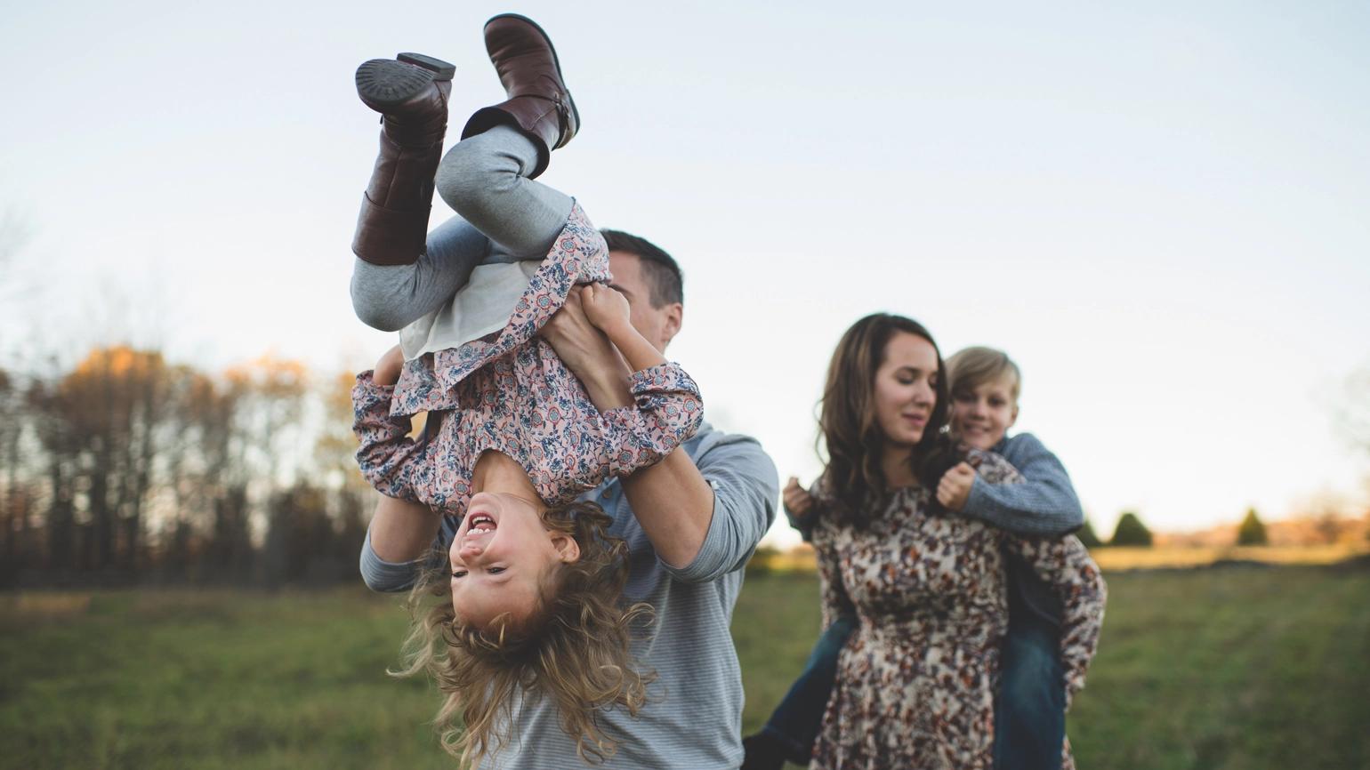 Family walking in the park father with the daughter and mother with a son Family walking in the park father with the daughter and mother with a son
