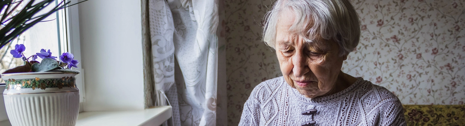 Older person looking at a paper letter Older person looking at a paper letter