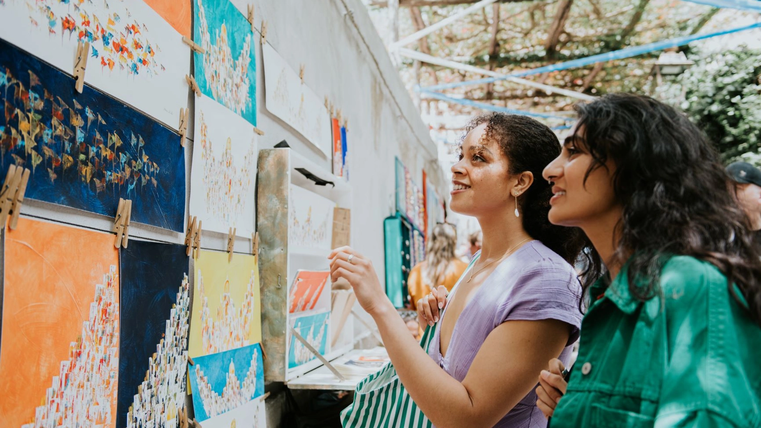 Two young female checking arts in the flea market Two young female checking arts in the flea market