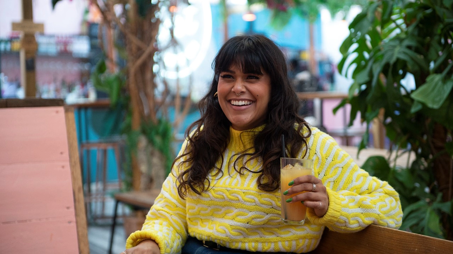 Female holding a cup of juice smiling Female holding a cup of juice smiling