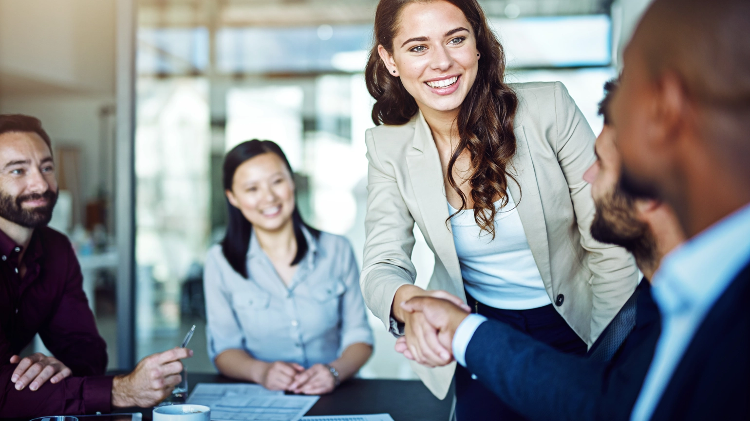 Female shaking with their client in the client meeting in office Female shaking with their client in the client meeting in office