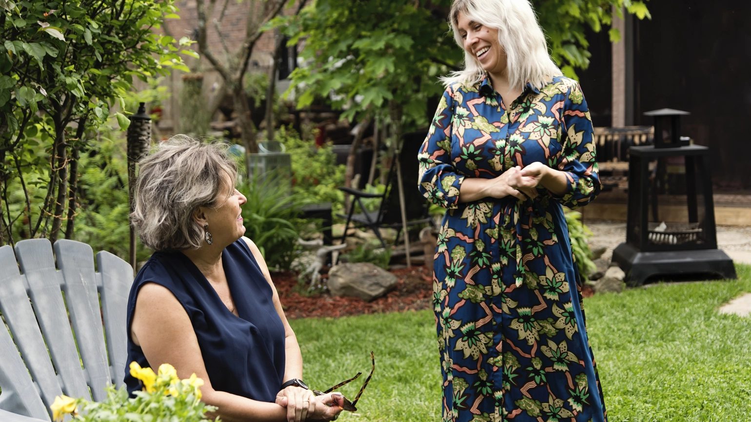 Two middle aged female chatting in the garden Two middle aged female chatting in the garden